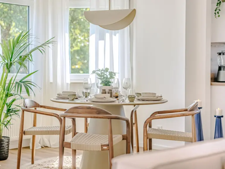 Dining area table with modern decor at Stay Eden MOONSTONE GREEN, a Ramstein TLA apartment.