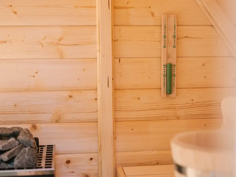 Exclusive Finnish sauna available at the Stay Eden MOONSTONE GREEN apartment in Ramstein, featuring wood interiors and a relaxing atmosphere.