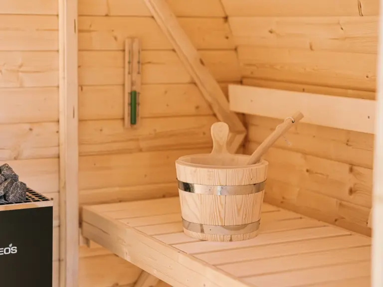Finnish sauna at the Stay Eden MOONSTONE GREEN apartment in Ramstein, designed for relaxation with warm wooden interiors.