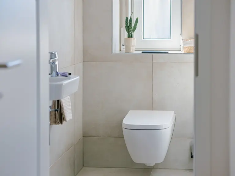 Half bath in the Stay Eden MOONSTONE GREEN apartment in Ramstein, featuring a modern sink and clean, minimalist design.