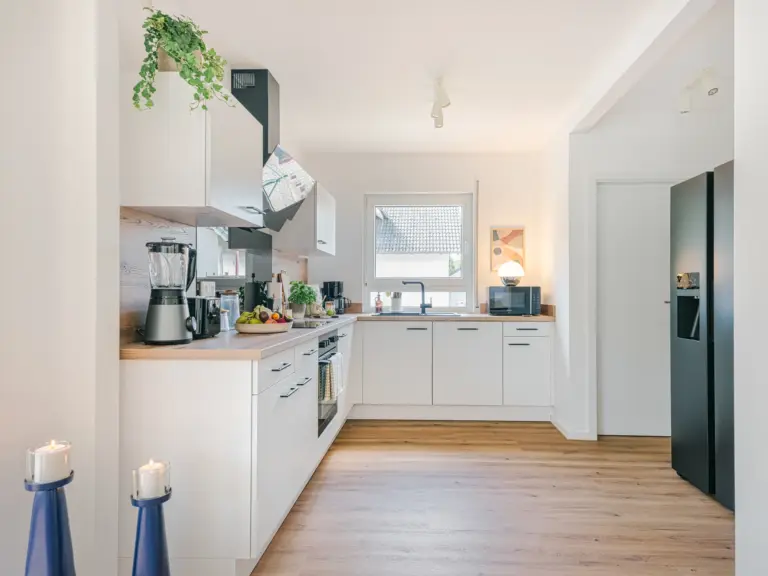 Kitchen with side-by-side fridge and modern appliances at Stay Eden MOONSTONE GREEN, a Ramstein TDY lodging option.