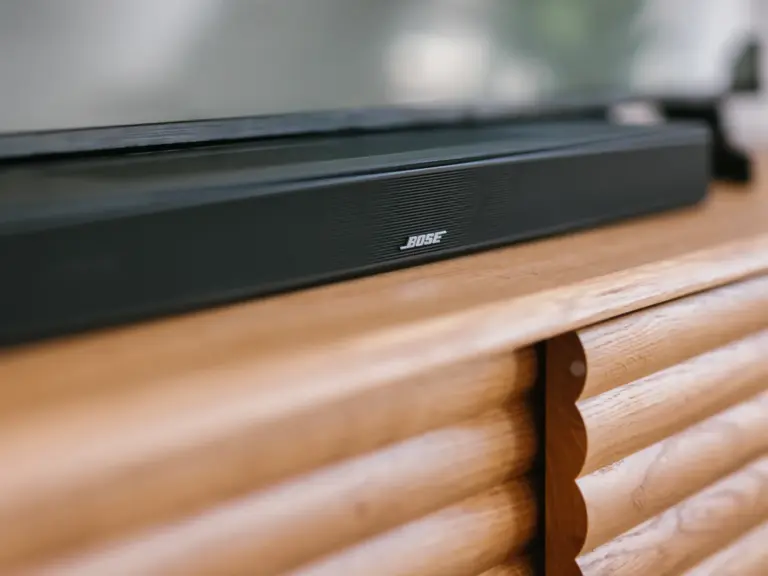 Bose soundbar in the living room of the Stay Eden MOONSTONE GREEN apartment in Ramstein, positioned beneath the TV for enhanced audio.
