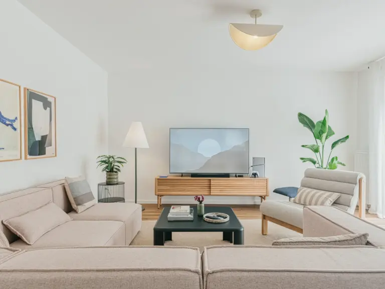 Living room of the Stay Eden MOONSTONE GREEN apartment in Ramstein, featuring a cozy sofa, modern décor, and a bright, open layout.