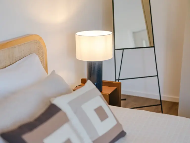 Modern nightstand in the master bedroom of the Stay Eden MOONSTONE GREEN apartment in Ramstein, styled with contemporary décor.