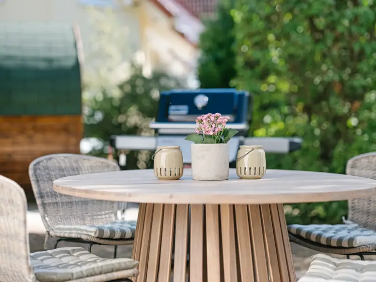 Private terrace at the Stay Eden MOONSTONE GREEN apartment in Ramstein, equipped with outdoor seating and a Weber grill.