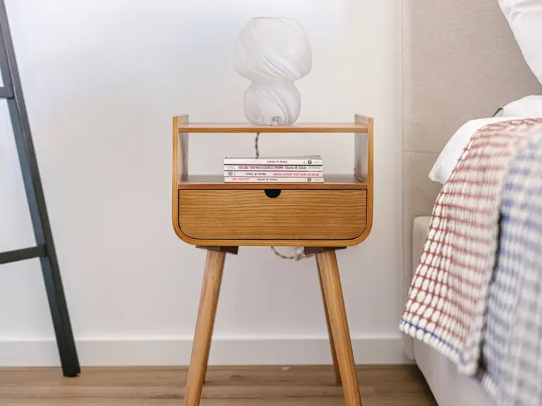 Stylish nightstand in the second bedroom of the Stay Eden MOONSTONE GREEN apartment in Ramstein, featuring modern décor elements.