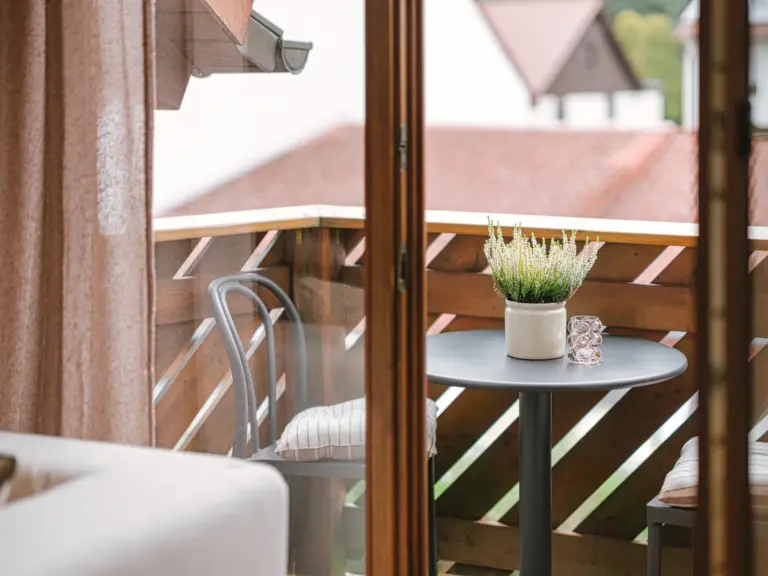 Balcony with outdoor seating and open view at Stay Eden TOPAZ BLUE near Ramstein Air Base.