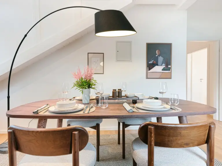 Dining area with modern table and stylish decor at Stay Eden TOPAZ BLUE near Ramstein Air Base.