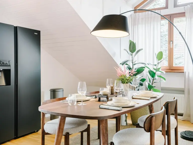 Dining area with modern table and chairs at Stay Eden TOPAZ BLUE near Ramstein Air Base.