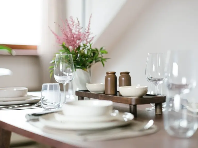 Dining table set with modern decor and warm lighting at Stay Eden TOPAZ BLUE near Ramstein Air Base.