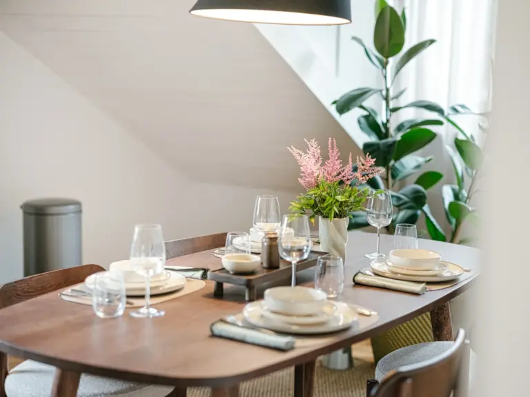 Dining table with modern decor and soft lighting at Stay Eden TOPAZ BLUE near Ramstein Air Base.