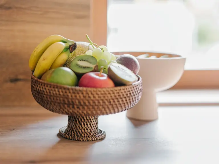 Kitchen with fruit basket and modern white cabinetry at Stay Eden TOPAZ BLUE near Ramstein Air Base.
