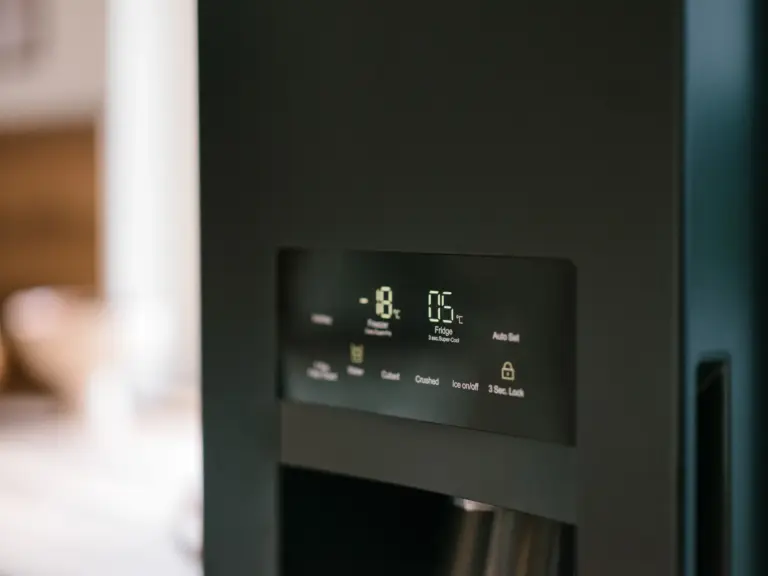 Kitchen with side-by-side fridge and modern appliances at Stay Eden TOPAZ BLUE near Ramstein Air Base.