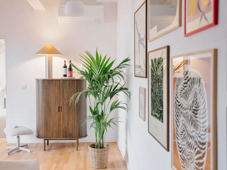 Living room sideboard with decorative plant and modern accents at Stay Eden TOPAZ BLUE near Ramstein Air Base.