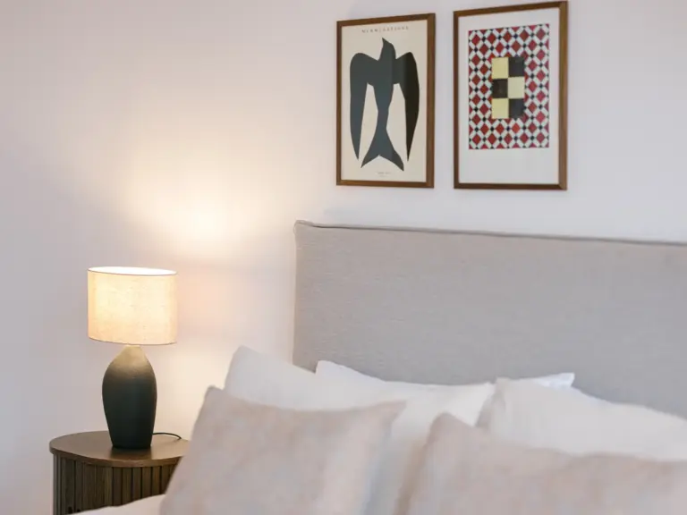 Master bedroom with cozy pillows and king-size bed at Stay Eden TOPAZ BLUE near Ramstein Air Base.