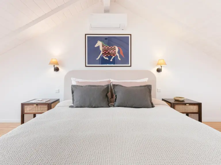Second bedroom bed view with cozy linens and warm lighting at Stay Eden TOPAZ BLUE near Ramstein Air Base.