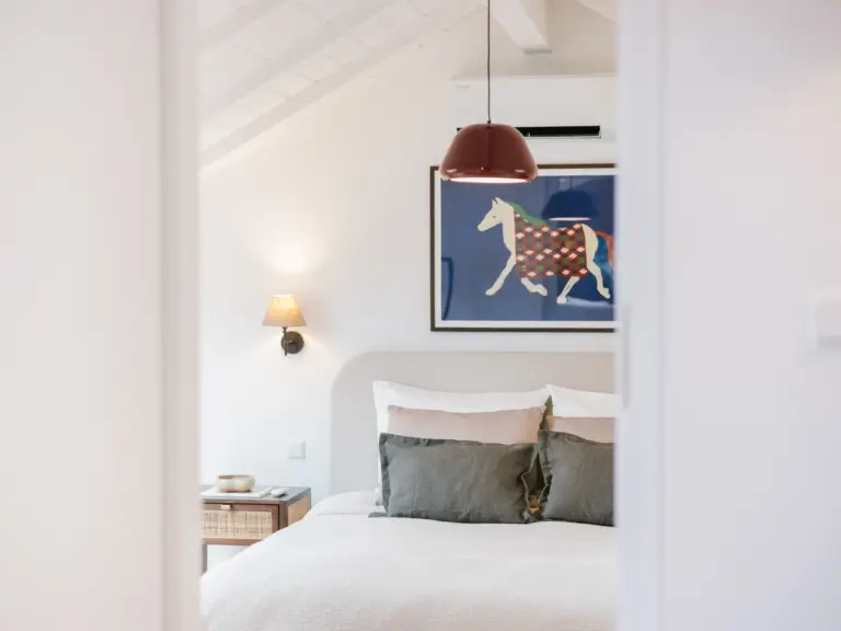 Door view of second bedroom with king-size bed and soft lighting at Stay Eden TOPAZ BLUE near Ramstein Air Base.
