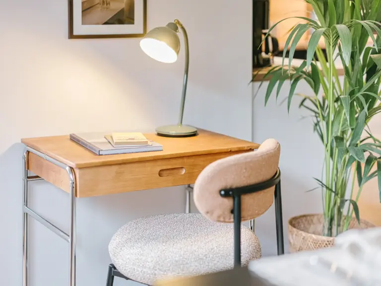 Workspace with desk lamp and chair at Stay Eden TOPAZ GREEN near Ramstein Air Base.