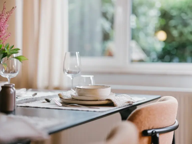 Close-up of dining table with elegant decor at Stay Eden TOPAZ GREEN near Ramstein Air Base.