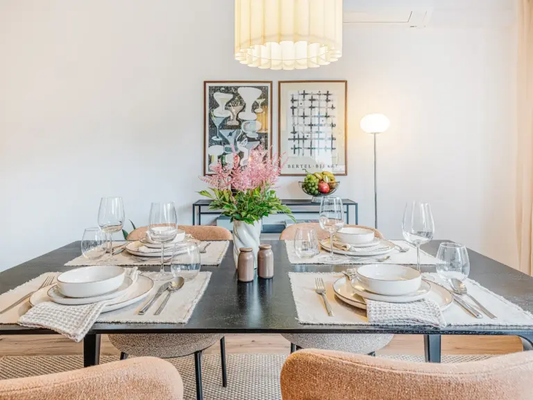 Dining table with modern setup and warm lighting at Stay Eden TOPAZ GREEN near Ramstein Air Base.