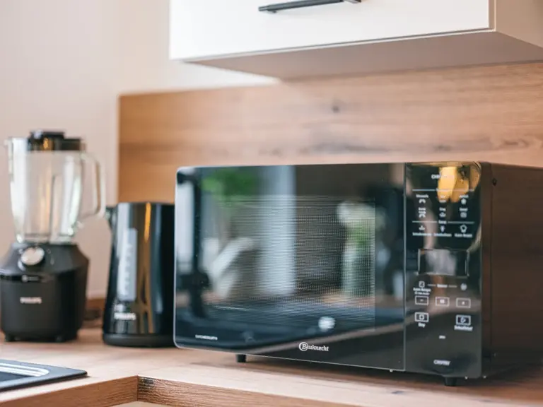Kitchen with microwave and modern cabinetry at Stay Eden TOPAZ GREEN near Ramstein Air Base.
