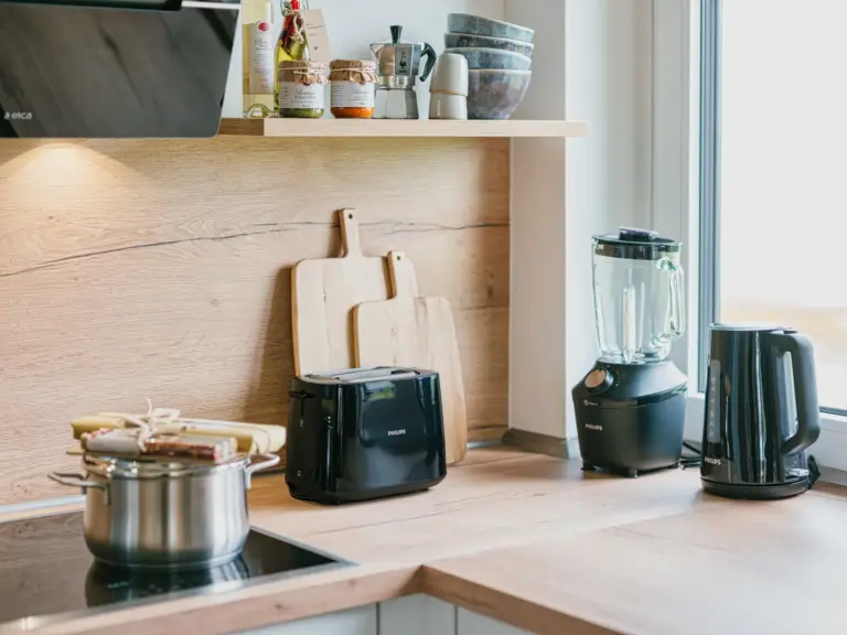 Kitchen in the Stay Eden SAPPHIRE BLUE apartment in Ramstein, featuring a modern stove and sleek countertop workspace.