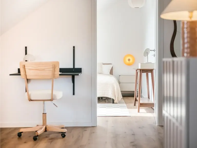 Second bedroom in the Stay Eden SAPPHIRE BLUE apartment in Ramstein, featuring a comfortable bed and an integrated dedicated workspace.